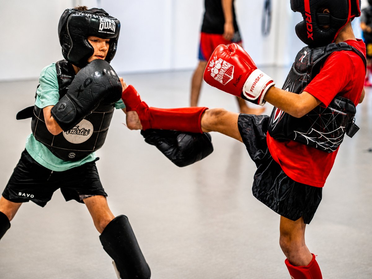 Kids boxing and Muay Thai kickboxing class at Ramona MMA Center, students drilling with full gear
